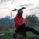 Masked man on an e Scooter