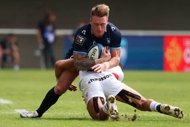 Montpellier's Scottish full-back Stuart Hogg (UP) is tackled by Toulouse's French wing Matthis Lebel.