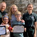 Arianna Liddle (centre), her brother Oliver (centre right) and their mother, Donna (second right), with Scottish Ambulance Service staff. Picture: Scottish Ambulance Service/SWNS