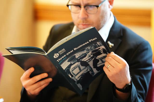 Journalists read Police Scotland's Three Year Business Plan . Picture: Andrew Milligan/PA Wire