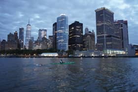 Andy Donaldson swimming in front of the Manhattan backdrop