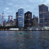 Andy Donaldson swimming in front of the Manhattan backdrop