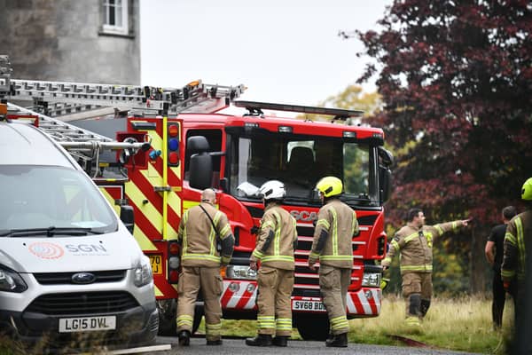 Firefighters attend the incident at the former luxury hotel. Picture: Michael Gillen