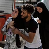 A woman reacts at the scene of an Israeli airstrike in the town of Maisara, north of Beirut