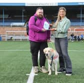 Jon Attenborough and his Labrador Sam with the SPFL's Molly Hyde at Station Park, Forfar. Picture: SPFL/Christopher Coutts/SWNS