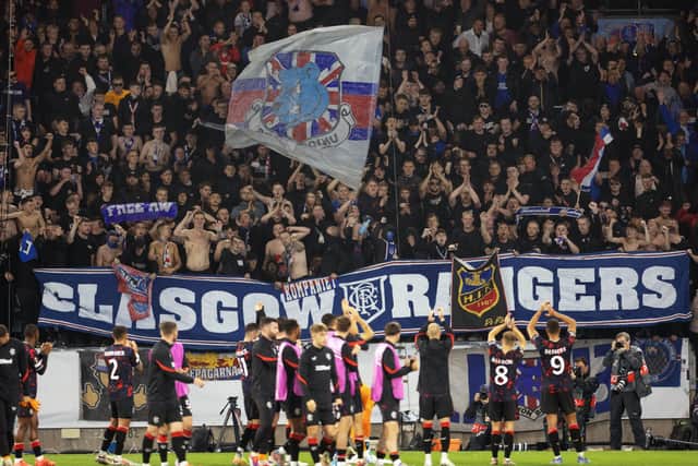 The Rangers player take the acclaim of the visiting support.