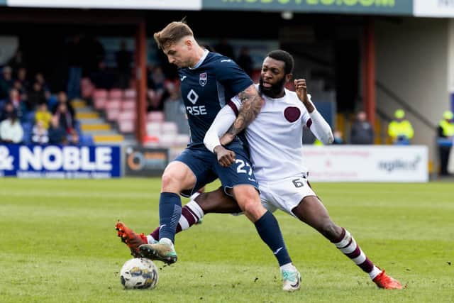 Ross County's Eamonn Brophy (left) in action.