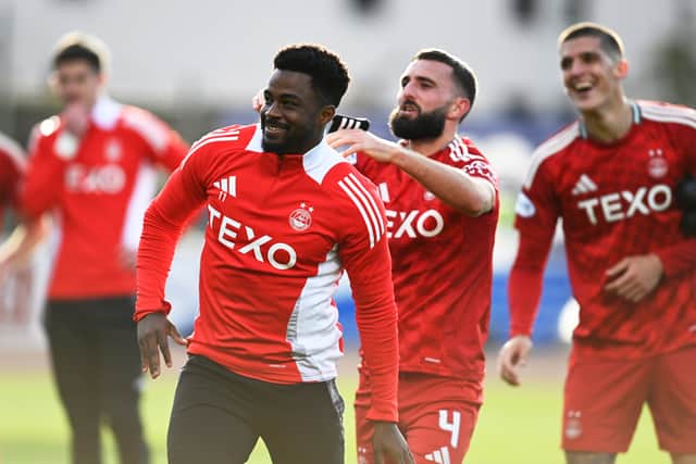 Graeme Shinnie thrusts Duk into the spotlight in front of the Aberdeen fans.