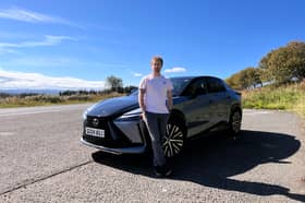 Steven Chisholm poses with the Lexus RZ300e test car near Glen Fruin