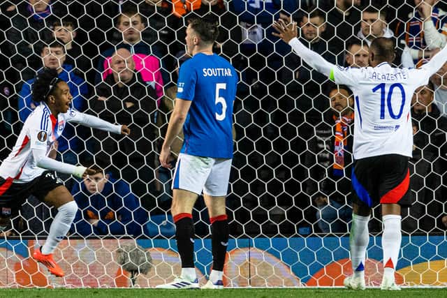 Lyon's Malick Fofana celebrates with Alexandre Lacazette - the duo tortured Rangers.
