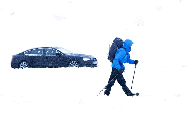 A walker makes their way through the snow in the Cairngorms National Park near Aviemore.