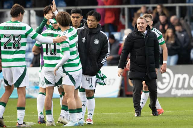 Brendan Rodgers watches his team celebrate the win over County.
