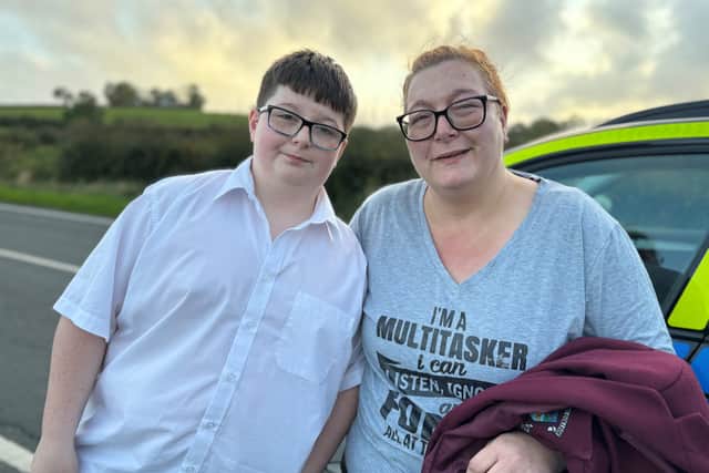 Dylan Lee, 12, and his mother Stacey Lee on the outskirts of Newtownards following a school bus crash on the Ballyblack Road East near Carrowdore in Northern Ireland on Monday afternoon