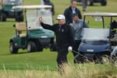 Former US President Donald Trump waves whilst playing a round of golf at Trump Turnberry. Picture: Leon Neal/Getty Images