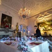 House Butler Michael Russell puts the finishing touches to the Christmas displays in The Pink Dining Room at Dumfries House, in Cumnock. Picture: PA
