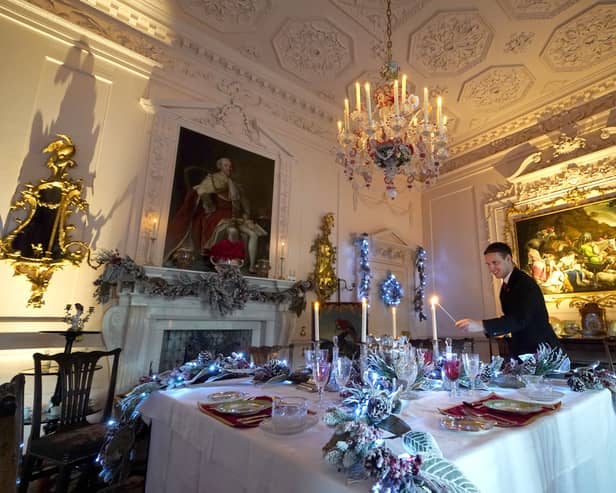 House Butler Michael Russell puts the finishing touches to the Christmas displays in The Pink Dining Room at Dumfries House, in Cumnock. Picture: PA