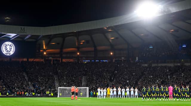 Players and fans observe a minute's applause for former First Minister Alex Salmond before the match between Scotland and Portugal at Hampden Park stadium in Glasgow on Tuesday evening
