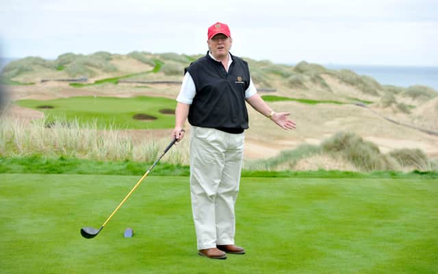 Donald Trump poses for the press on the thirteenth tee of his golf course on the Menie Estate, Balmedie, Aberdeenshire