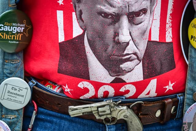 A supporter of Republican US presidential candidate Donald Trump shows his allegiance outside a campaign rally in West Palm Beach, Florida, earlier this year (Picture: Giorgio Viera)
