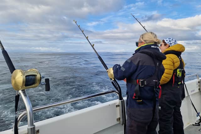 Preparing the rods to catch bluefin tuna from Angus Campbell's fishing vessel under a catch tag and release permit for research