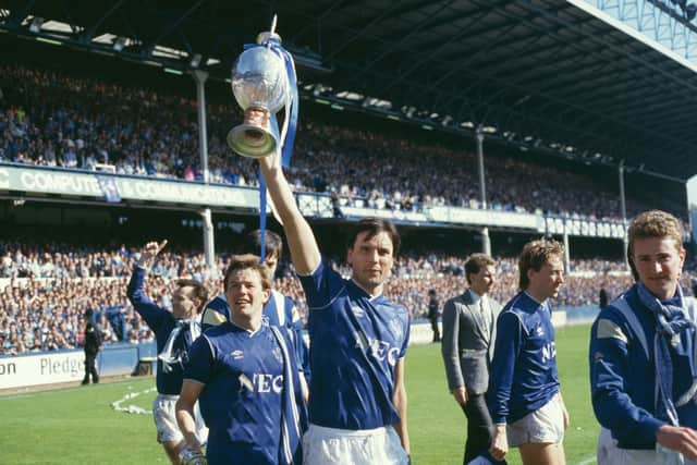 Sharp lifts the Division One trophy at Goodison Park.