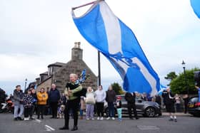 A piper plays outside after the coffin of former first minister of Scotland Alex Salmond arrives at a funeral parlour in Fraserburgh. PIC: PA.