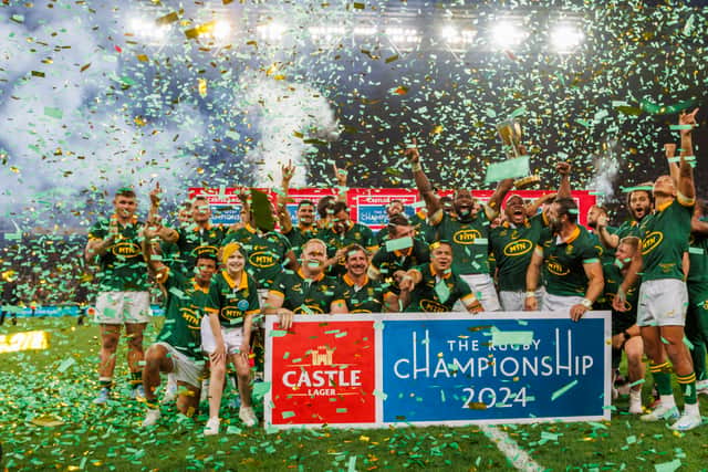 Siya Kolisi of South Africa lifts the trophy with teammates after winning the 2024 Rugby Championship.