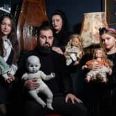 JP Kennedy and Kymmi Jeffery with daughters Snow and Pebble (L-R), known as The Occult Family, holding haunted dolls inside their haunted room.