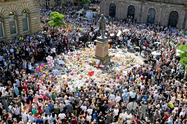 Members of the public observe a minute's silence in memory of the victims of the 2017 Manchester Arena bombing. Picture: Jeff J Mitchell/Getty Images