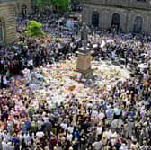 Members of the public observe a minute's silence in memory of the victims of the 2017 Manchester Arena bombing (Picture: Jeff J Mitchell)