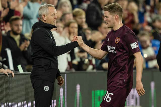 Neil Critchley congratulates Blair Spittal on his performance for Hearts against Omonoia.