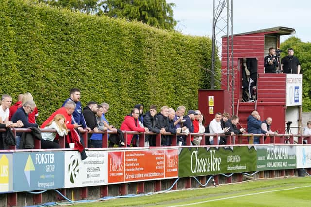Fans watch a game from in front of the famous hedge at Brechin City's Glebe Park ground (Picture: Simon Wootton)