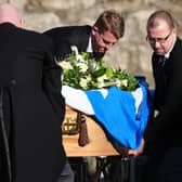 Pall bearers with the coffin, draped in a Saltire flag, arriving for the funeral service for former first minister Alex Salmond. Picture: Andrew Milligan/PA Wire