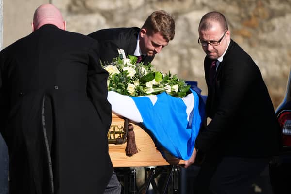 Pall bearers with the coffin, draped in a Saltire flag, arriving for the funeral service for former first minister Alex Salmond. Picture: Andrew Milligan/PA Wire