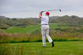 US tycoon Donald Trump plays a stroke as he officially opens his new multi-million pound Trump International Golf Links course in Aberdeenshire in 2012. Picture: Andy Buchanan/AFP via Getty Images