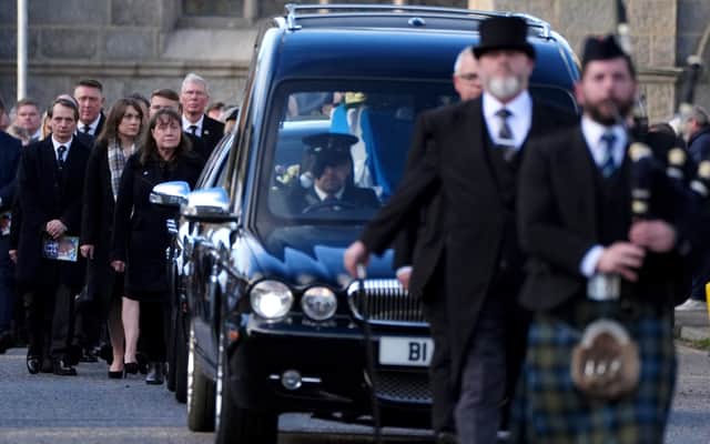 Gail Hendry, third left, the sister of Alex Salmond, follows the funeral cortege as it leaves the funeral service for the former first minister at Strichen Parish Church in Strichen, Aberdeenshire