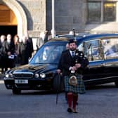 Piper Fergus Mutch, who previously worked for Alex Salmond, leads the cortege as it leaves the funeral service for the former first minister at Strichen Parish Church in Aberdeenshire