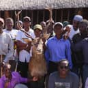 Community members pose for a photograph with a Stags head