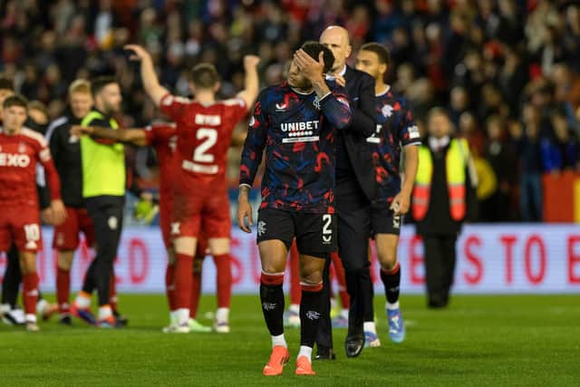 Captain James Tavernier holds his head in his hands.