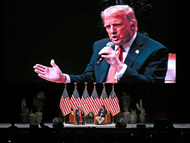 Donald Trump is projected on a giant screen during a live interview with US commentator Tucker Carlson in Glendale, Arizona (Picture: Patrick T Fallon)