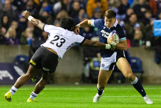 Tom Jordan tries to skip past Fiji's Waqa Nalaga on his Scotland debut.