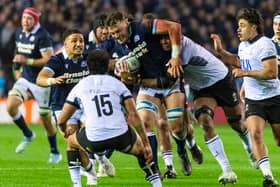 Scotland No 8 Jack Dempsey takes the game to Fiji, with support from Sione Tuipulotu.