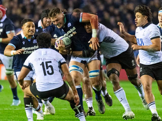 Scotland No 8 Jack Dempsey takes the game to Fiji, with support from Sione Tuipulotu.