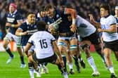 Scotland No 8 Jack Dempsey takes the game to Fiji, with support from Sione Tuipulotu.
