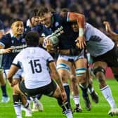 Scotland No 8 Jack Dempsey takes the game to Fiji, with support from Sione Tuipulotu.