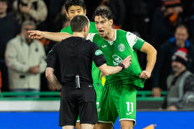Hibs captain Joe Newell argues with referee Colin Steven after Mykola Kuharevich is sent off and a penalty awarded to Dundee United following a VAR check. (Photo by Ross Parker / SNS Group)