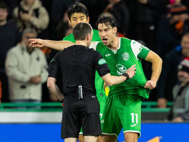 Hibs captain Joe Newell argues with referee Colin Steven after Mykola Kuharevich is sent off and a penalty awarded to Dundee United following a VAR check. (Photo by Ross Parker / SNS Group)