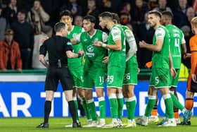 Hibs player plead their case to referee Colin Steven after two controversial decisions at the end of their game with Dundee United at Easter Road. Cr: SNS Group.