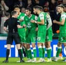 Hibs player plead their case to referee Colin Steven after two controversial decisions at the end of their game with Dundee United at Easter Road. Cr: SNS Group.
