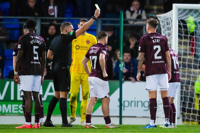 Hearts' Cammy Devlin (R) is shown a yellow card by Referee Chris Graham for a foul on St Johnstone's Kyle Cameron in the penalty area. Cr: SNS Group.